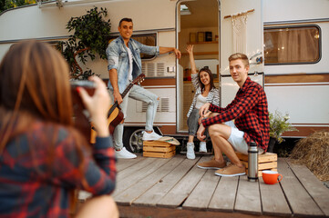 Wall Mural - happy friends poses near rv on picnic at camping
