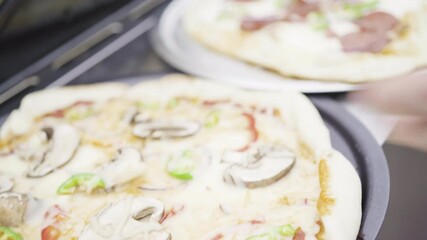 Wall Mural - Preparing individual grilled pizzas on an outdoor gas grill.