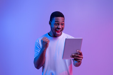 Wall Mural - Online Win. Joyful African American Guy Celebrating Success With Digital Tablet,