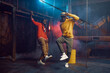 Two stylish rappers, breakdancing in studio