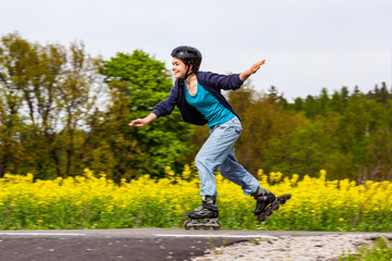 Wall Mural - Teenage girl rollerblading against blue sky
