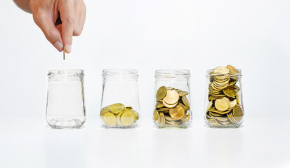 Poster - business man hand put coin on glass jar with many coins step growth up on white table against white background. money saving and owner investment concept for business financial.