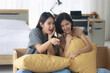 © amornchaijj - Two Asian teenage girls are Intimate friends with short and long hair they are happy to watch movies and series on TV in the bedroom. Young women are enjoying leisure activities.