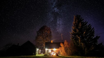 Wall Mural - milky way timelapse with stars in clear summer night. old barn house. country side. timelapse footag