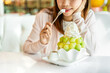 © Kittiphan - Young woman enjoy eating melon bingsu in restaurant