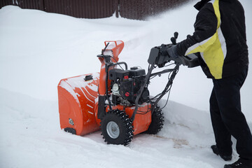 Wall Mural - A portable snow blower powered by gasoline. Snow removal in winter.