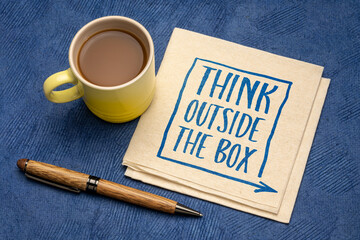 think outside the box - inspirational concept - handwriting on a napkin with a cup of coffee, business, education and personal development