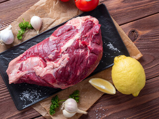 Canvas Print - a piece of marbled beef lies on parchment surrounded by herbs, garlic, salt. Top view, flat lay. food composition