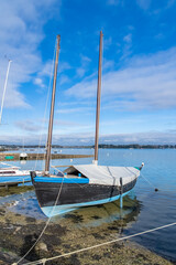 Canvas Print - Brittany, the Ile aux Moines, with a sailing boat in the harbor in winter
