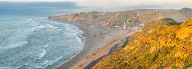 Wall Mural - an idyllic coastline view with the waves from the ocean smashing the sand in the coast. an amazing p