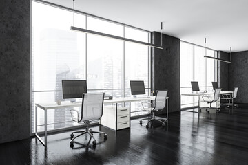 Black business room with chairs and table with computers near window