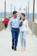 © auremar - a couple walking on a pier on a lakeside