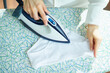 woman ironing panties with steam generator on ironing board