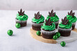 Delicious chocolate cannabis cupcakes infused with cannabis. Cannabis concept for a marijuana themed party. 