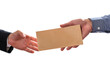 Man giving bribe money in brown envelope to another businessman in corruption scam. Closeup of hands giving envelop with bribe isolated on white background