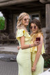 © BY-_-BY - Portrait of two pretty young bridesmaids in yellow dresses