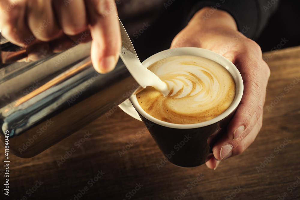 Milk foam poured into a  cup to form a perfect cappuccino - obrazy, fototapety, plakaty 