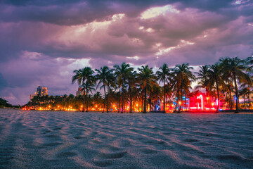 Wall Mural - miami florida beach palms lights business nightclubs restaurants lights illuminated sky clouds sand tropical sunset beautiful 