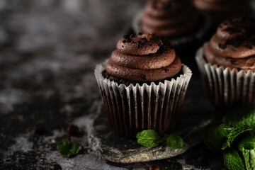 Sticker - Chocolate Cupcakes on dark moody background, selective focus