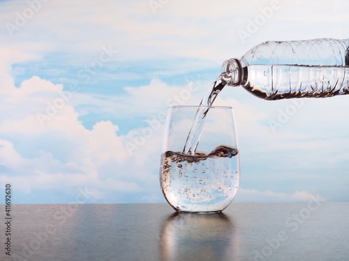 Close-up Of Water Pouring In Glass On Table Against Sky © จิรพรรณ วิสุทธิรัตน์โสภณ/EyeEm