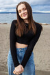 © Mat Hayward - Teenage girl outside at Alki Beach in West Seattle with a view of the Puget Sound and the city of Seattle in Washington State.