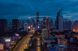 Fototapeta Miasto - Night aerial wide view of skyscrapers and multi lane highway in large urban city center Cityscape of high rise buildings in Jakarta, Indonesia at night