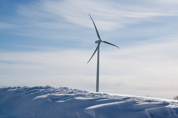 wind generators under blue sky, snow landscape .Powerplant electric turbine. clean energy and eco energy concept