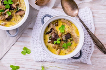 Poster - Delicious mushroom soup in serving pot on wooden table