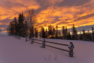 Wall Mural - a fiery, dramatic sunrise in a winter mountain scenery