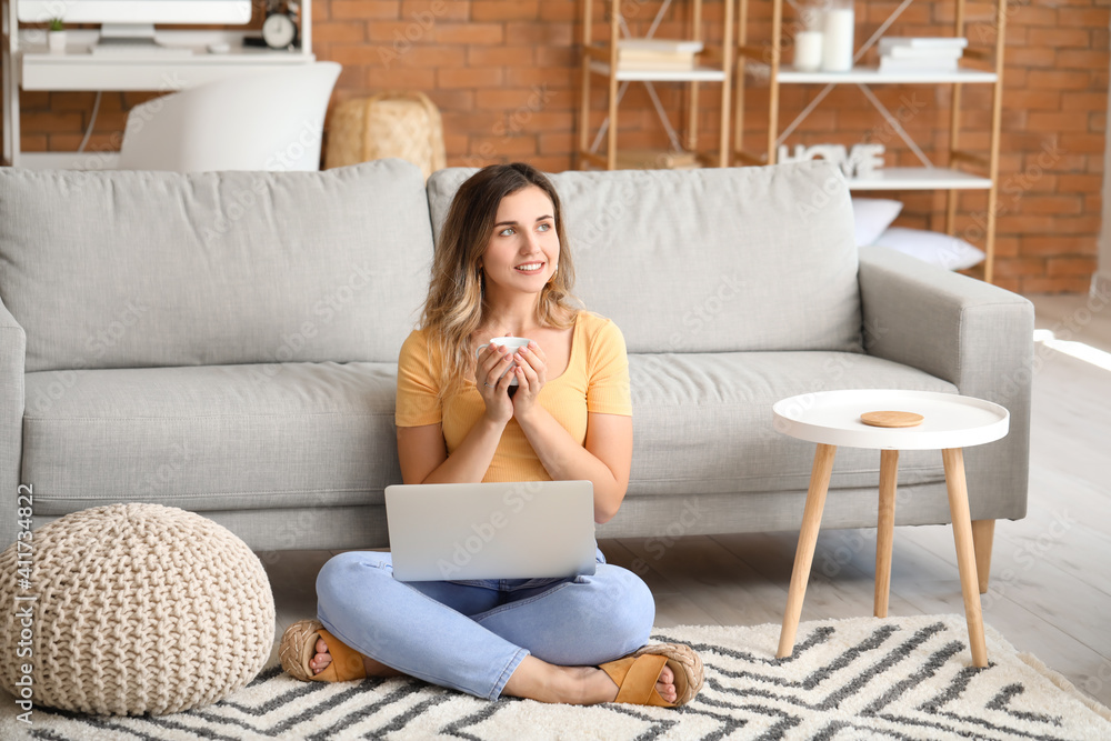Young woman with laptop at home