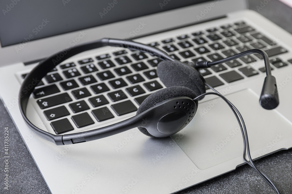 Headset with laptop on table, closeup