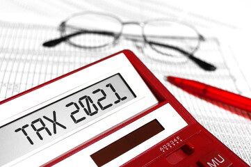 Wall Mural - Word Tax 2021 on calculator. Business and tax concept on white background. Top view.