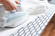 © Владислав Легір - Woman is ironing clothes. Woman holds an iron on an ironing board