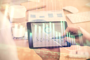 Double exposure of man's hands holding and using a phone and financial chart drawing. Market analysis concept.