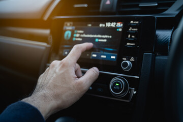 the driver using touch screen monitor in the modern car