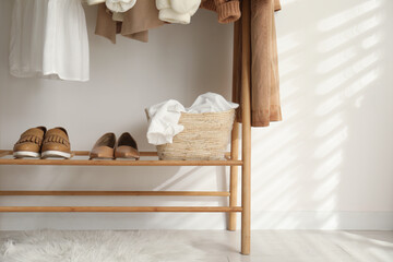 Wall Mural - Rack with stylish shoes and women's clothes indoors. Modern interior design