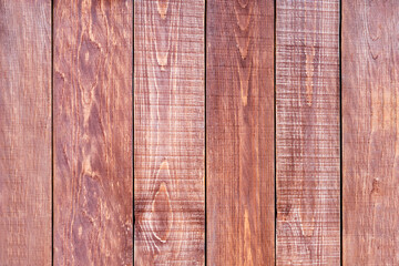 Old rustic dark brown boards. Close-up. Vertical wooden planks with texture. Natural surface background. Textured backdrop