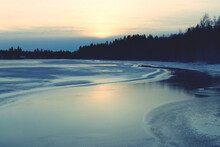 Scenic View Of Frozen Lake Against Sky During Sunset