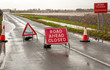 Road ahead closed and flood warning signs on the road to Cawood Bridge in Selby, North Yorkshire during Storm Christoph. The River Ouse has burst its banks and water is flooding into surrounding field