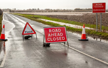 Road Ahead Closed And Flood Warning Signs On The Road To Cawood Bridge In Selby, North Yorkshire During Storm Christoph. The River Ouse Has Burst Its Banks And Water Is Flooding Into Surrounding Field