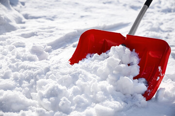 Wall Mural - Shoveling snow outdoors on sunny winter day, closeup