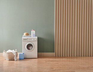 Washing machine in the green and wooden wall style with dirty clothes, laundry room style with detergent.