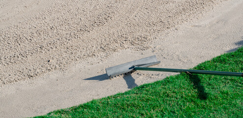 Wall Mural - Rake in the sand trap on a golf course