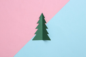 Wall Mural - Paper cut christmas tree on blue pink pastel background