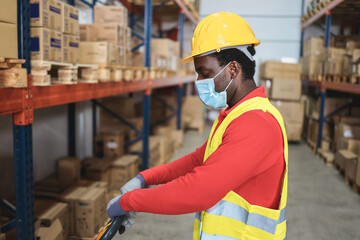 Sticker - African worker man pulling a pallet truck at warehouse store - Focus on face