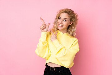 Canvas Print - Young blonde woman wearing a sweatshirt isolated on pink background pointing with the index finger a great idea