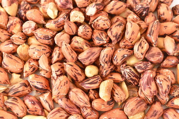 Wall Mural - close up of baked salty tiger stripe peel peanut background and texture on white background