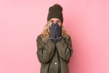 Canvas Print - Young girl with winter hat isolated on pink background with surprise facial expression