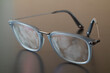 Eyeglasses with fingerprints over the lenses,  smudged finger marks 