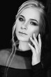 © omelnickiy - Blonde girl with blue eyes in a black dress